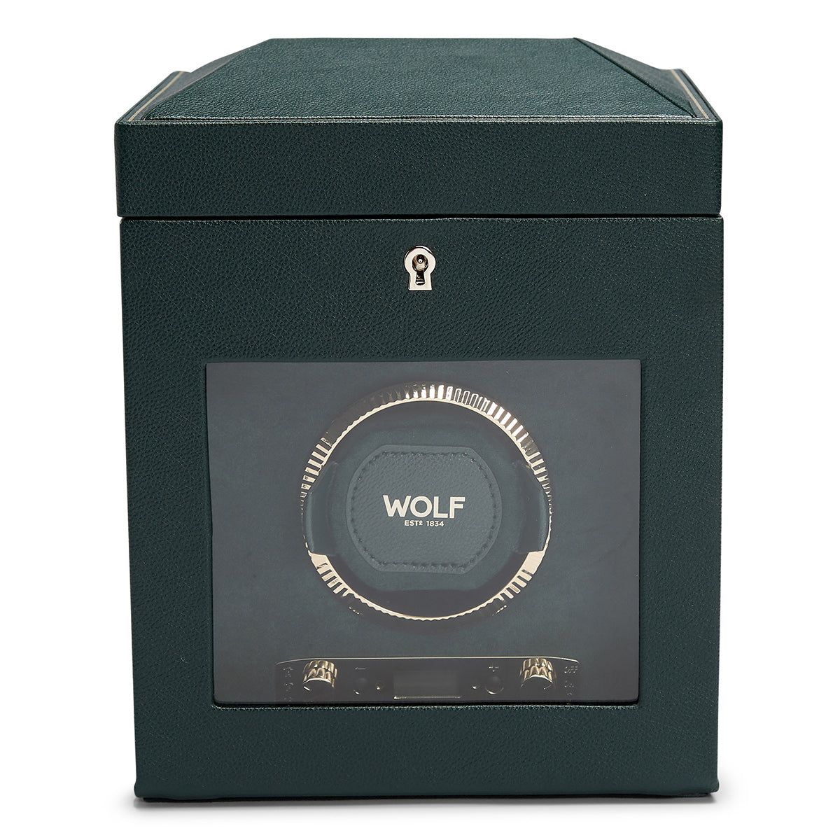 The WOLF 1834 British Racing Green Single Winder boasts a sleek design with a clear display window that reveals the intricate interior mechanism. Its exterior is textured to resemble vegan leather, and it features a small keyhole at the top center, enhancing its elegant British Racing theme.