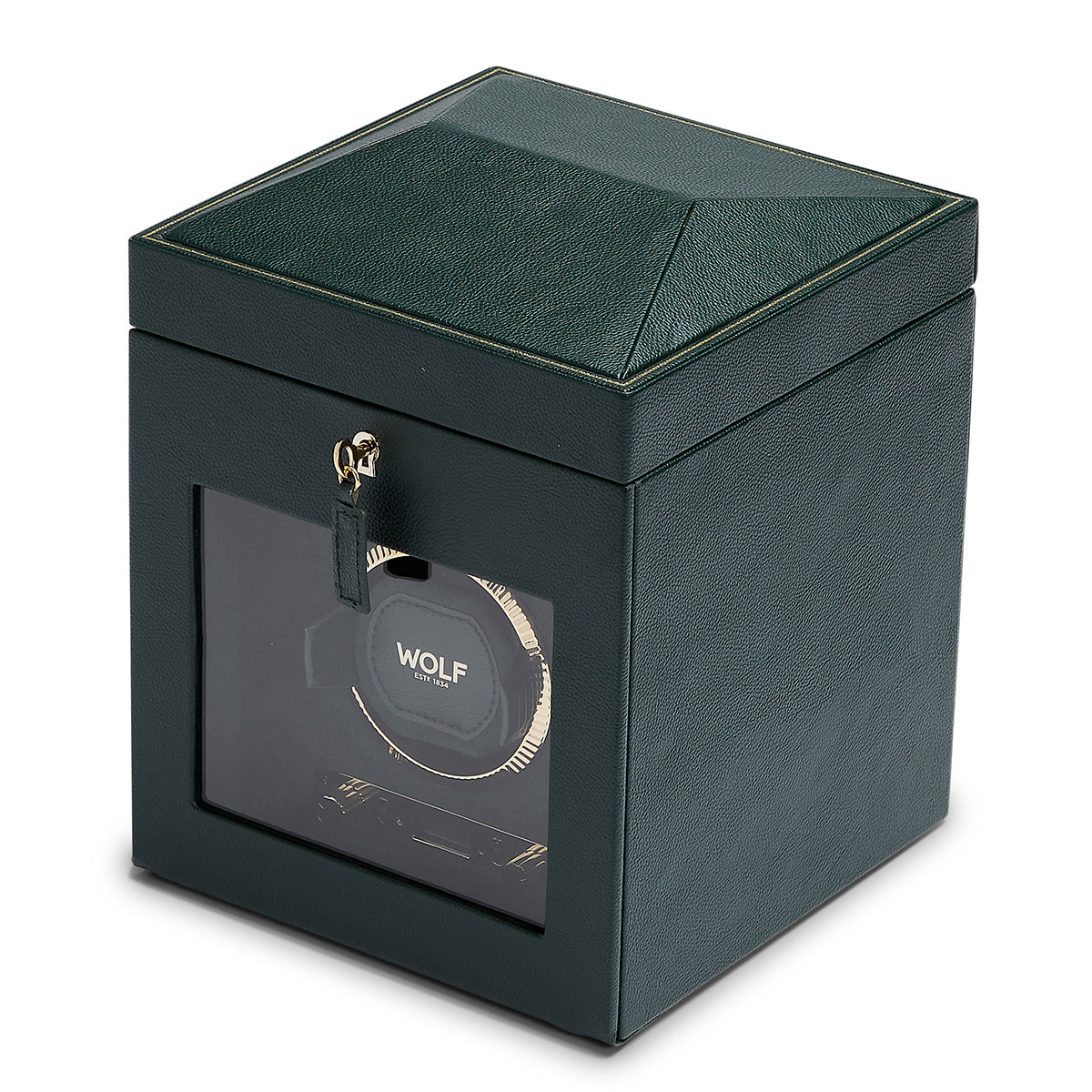 The WOLF 1834 British Racing Green Single Winder is a cubic piece crafted from vegan leather in a green hue, featuring a transparent viewing window on one side. The brand name "WOLF" is prominently displayed inside. Inspired by the British Racing style, it includes a hinged lid with stitching details and a front locking clasp.