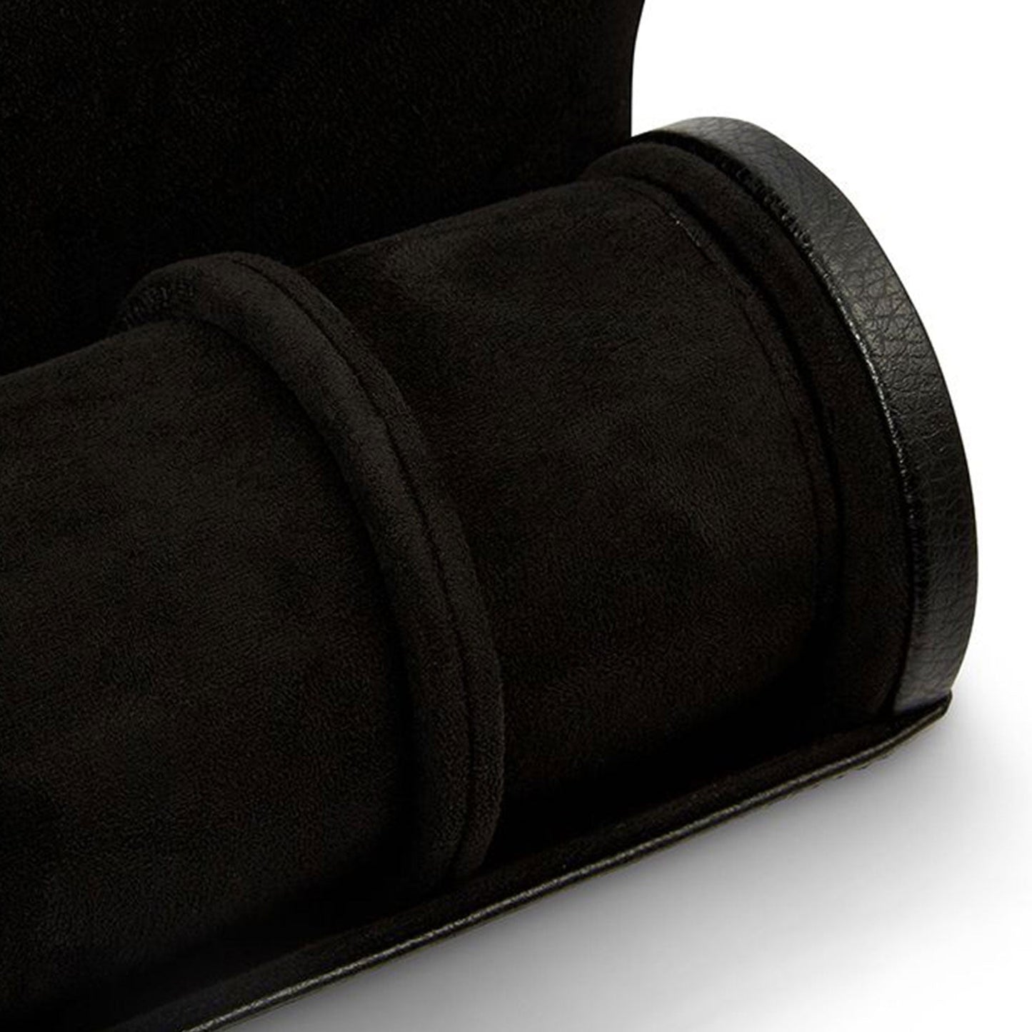 A close-up of the WOLF 1834 British Racing Triple Watch Rolls, showcasing its elegant blend of black suede and leather with intricate stitching details. This case is expertly designed to securely store your precious timepieces.