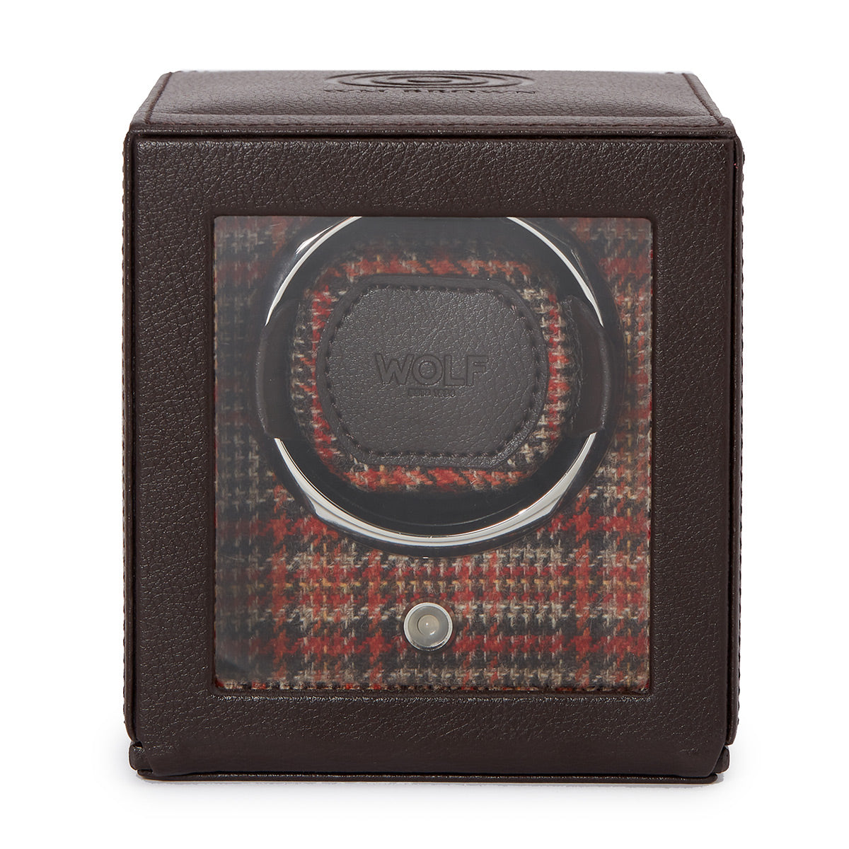 The WOLF 1834 WM Brown Single Watch Winder is a classic piece with a brown leather exterior and a glass front, showcasing the winder inside. The interior features a red and brown plaid pattern, and the holder is adorned with the "WOLF" brand name. It includes patented rotation programs designed for optimal watch care.