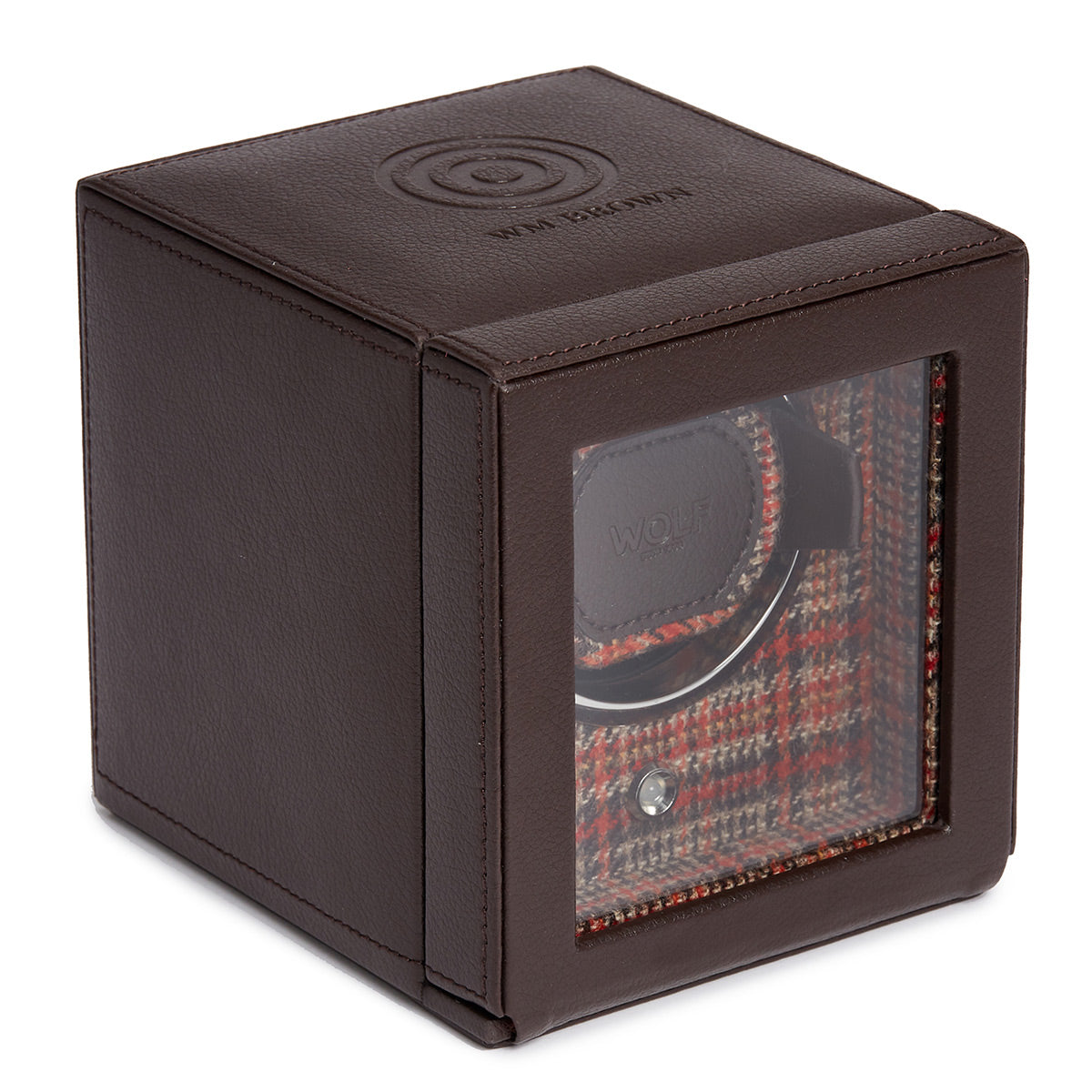 The WOLF 1834 WM Brown Single Watch Winder is a timeless piece featuring a transparent front that elegantly displays a single watch compartment. Its interior is adorned with vibrant plaid fabric, and the cube proudly bears the embossed brand name "WOLF." This watch winder incorporates patented rotation programs to ensure optimal care for your timepiece.