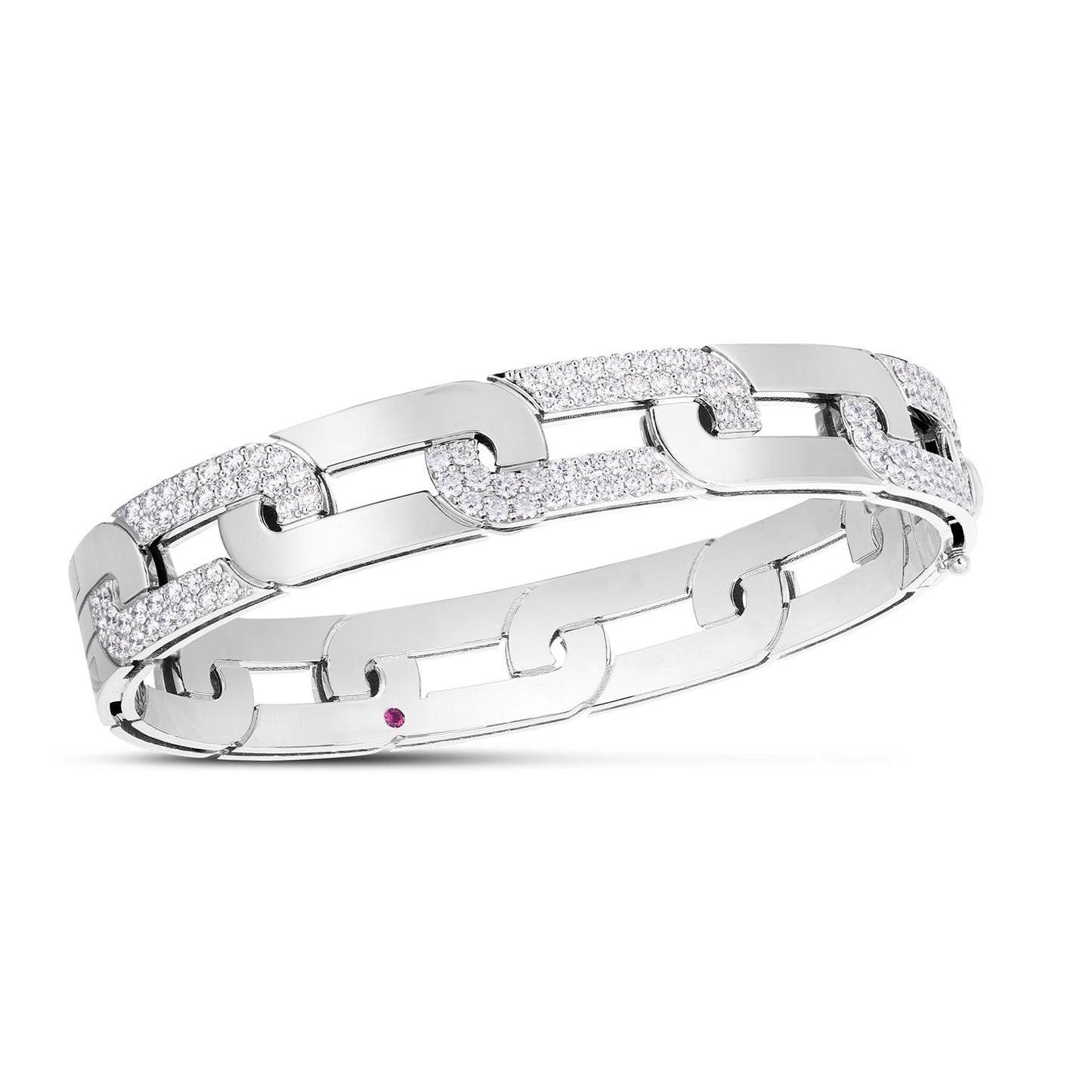 The Roberto Coin Navarra 18K White Gold Large Alternating Diamond Link Wide Bangle is a sophisticated jewelry piece featuring a sleek chain-link design. Each link is embellished with delicate, sparkling diamonds, exuding elegance. A single small pink gemstone accent on one of the links adds the perfect finishing touch to this luxurious bangle.