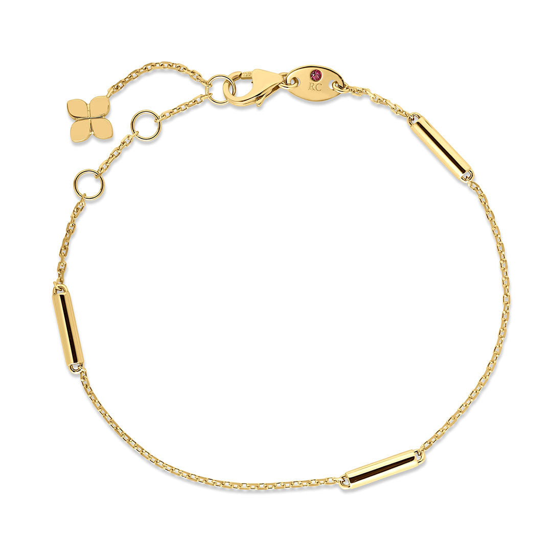 Roberto Coin Designer Gold 18K Yellow Gold Bar Station Bracelet featuring a slender yellow gold chain, cylindrical bar accents, a small four-leaf clover charm, and a lobster clasp.