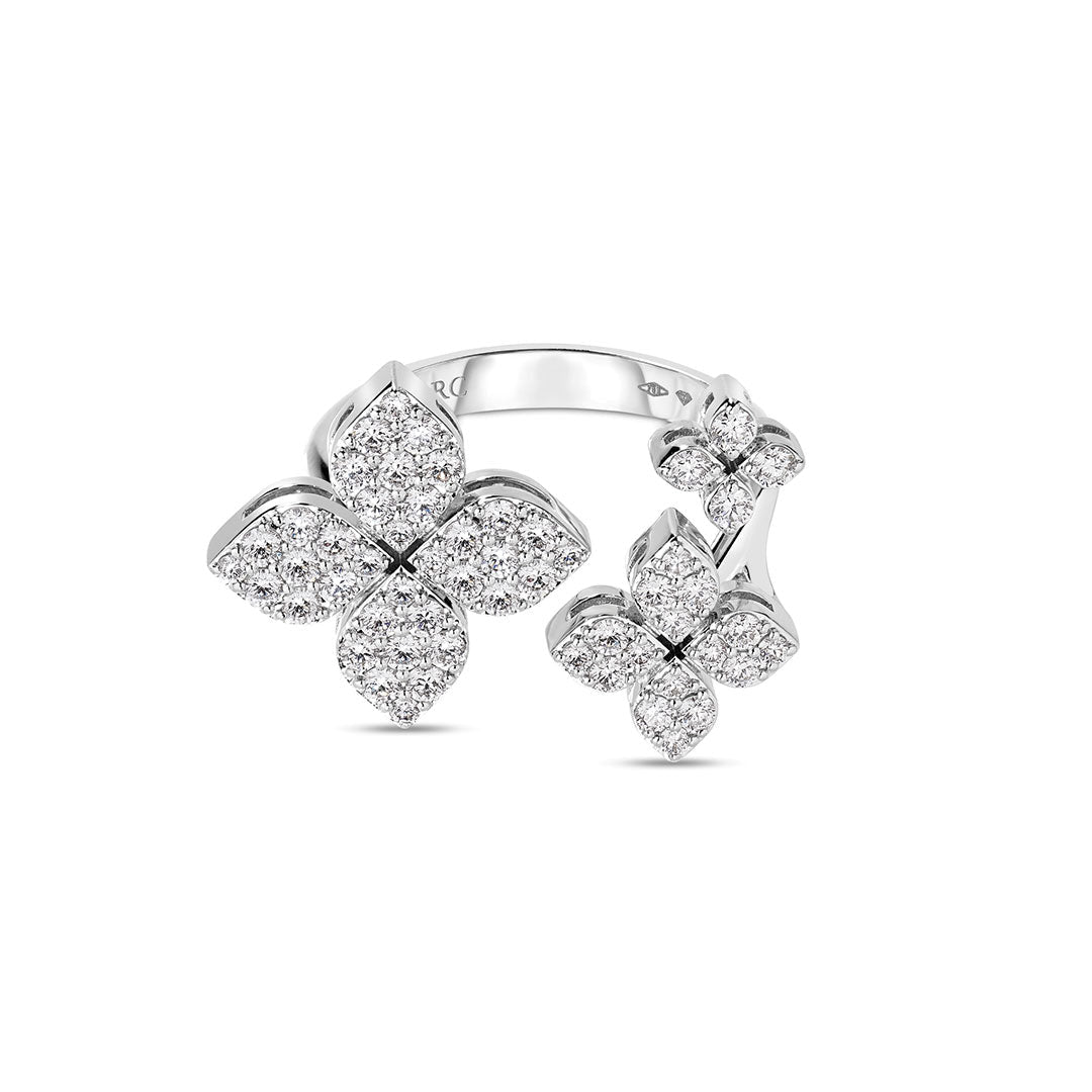 The Roberto Coin Love in Verona 18K White Gold Diamond Triple Flower Fashion Ring by Roberto Coin showcases three flower motifs adorned with sparkling SI1-SI2 clarity diamonds—one larger flower accompanied by two smaller ones—beautifully presented against a white background.