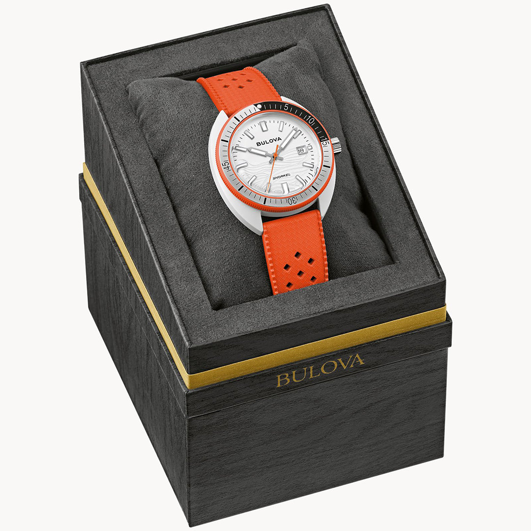 Inside a sleek black and gold Bulova box on a dark gray cushion lies the silver Bulova Snorkel Clownfish Quartz 41mm Watch with an orange band. This stylish timepiece boasts a white face, metal bezel, and hybrid ceramic elements, offering modern design and impressive water resistance.