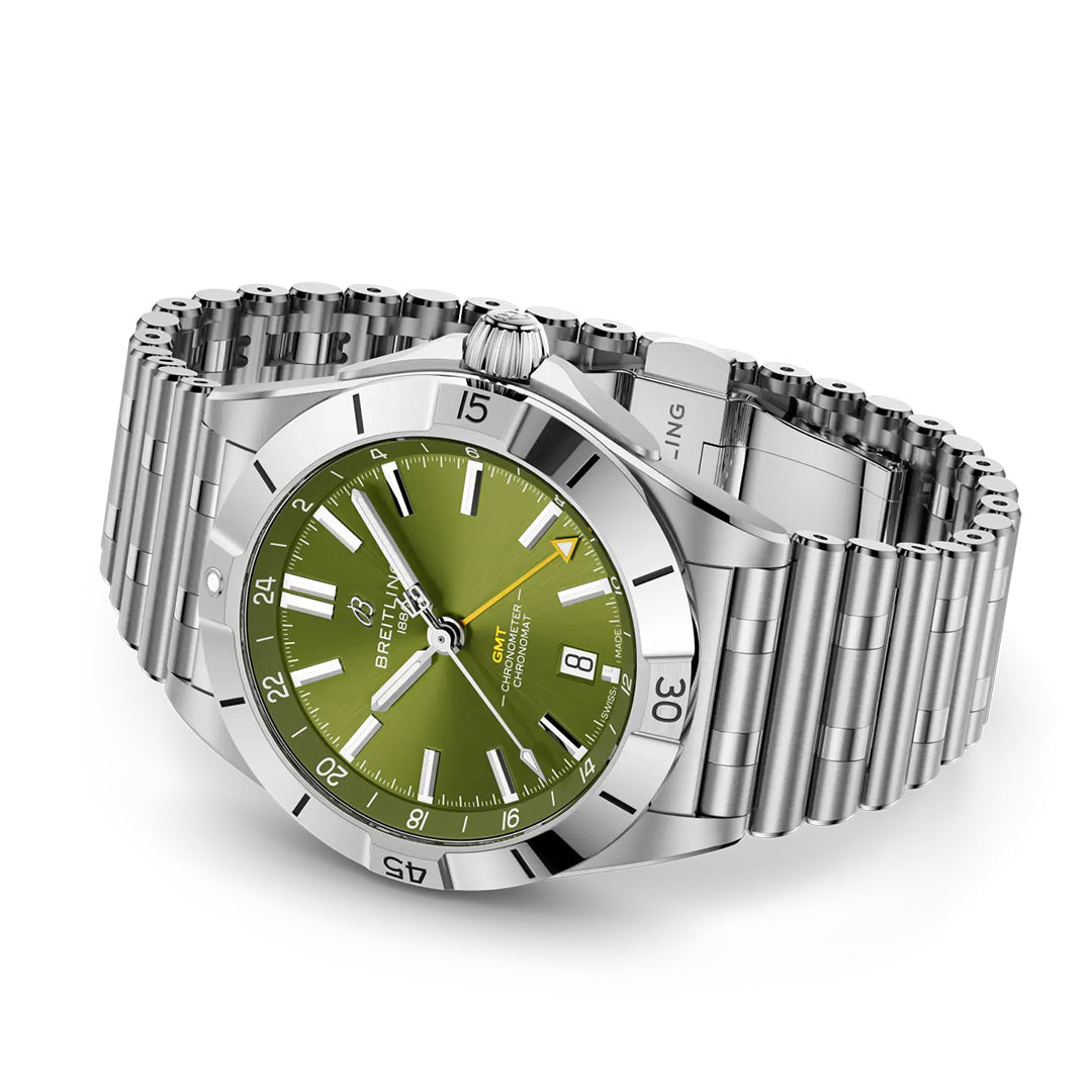 The BREITLING Chronomat Automatic GMT 40 Giannis Antetokounmpo features a green dial with date at 6 o'clock, luminous hour markers on a stainless steel rotating bezel, and the brand name under 12 o'clock. This silver wristwatch exudes sophistication with its metal bracelet.