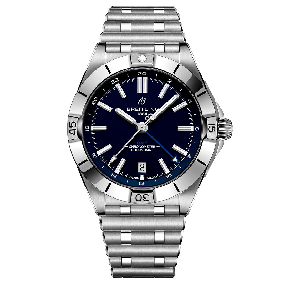 The BREITLING Chronomat Automatic GMT 40 is a stainless steel wristwatch with a dark blue dial, silver hour markers, date at 6 o’clock, metal link bracelet, engraved numeral bezel, and displays the time as 10:08.