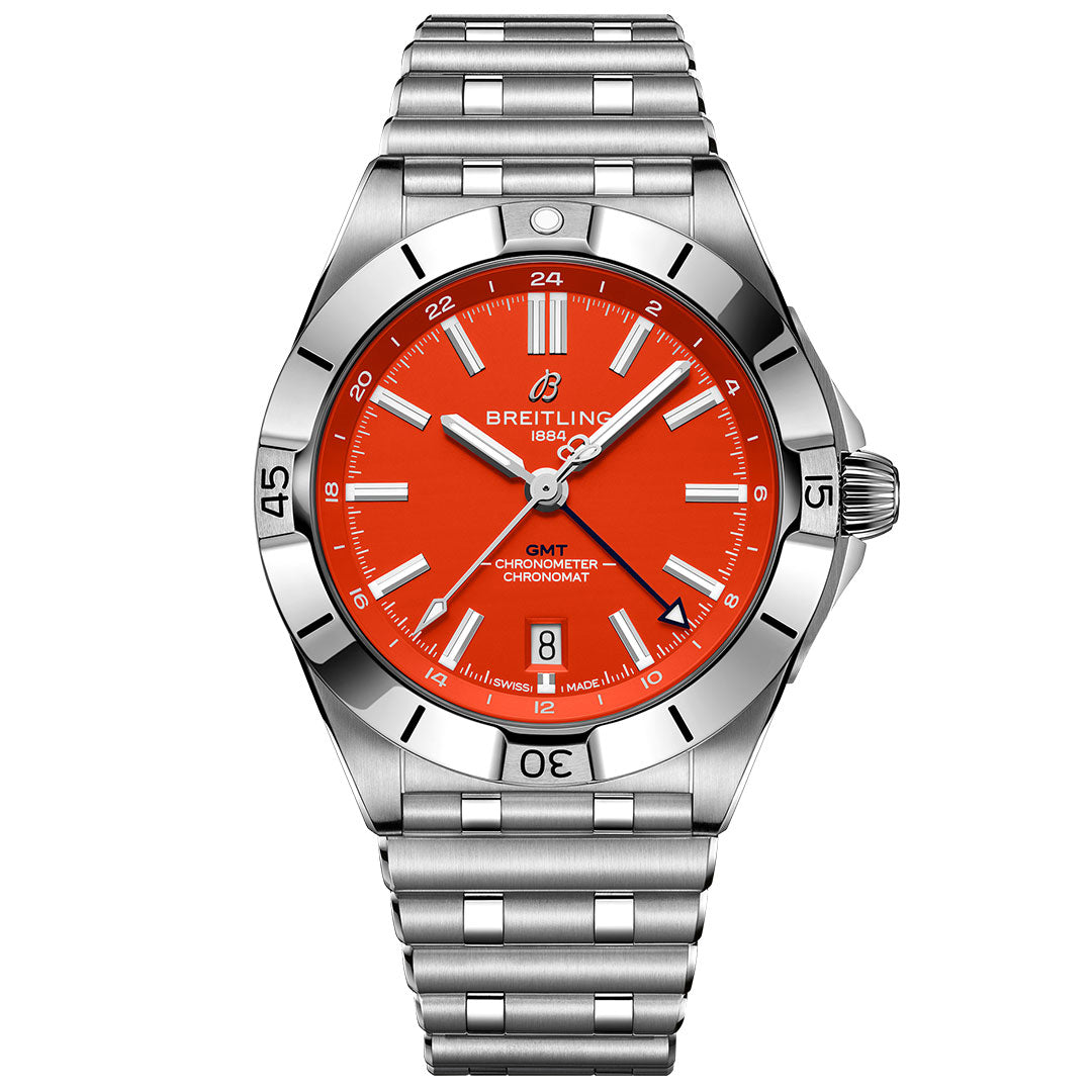 The BREITLING Chronomat Automatic GMT 40 is a stainless steel watch with a vivid orange dial, silver hour markers, date at 6 o’clock, metal link bracelet, and rotating bezel.