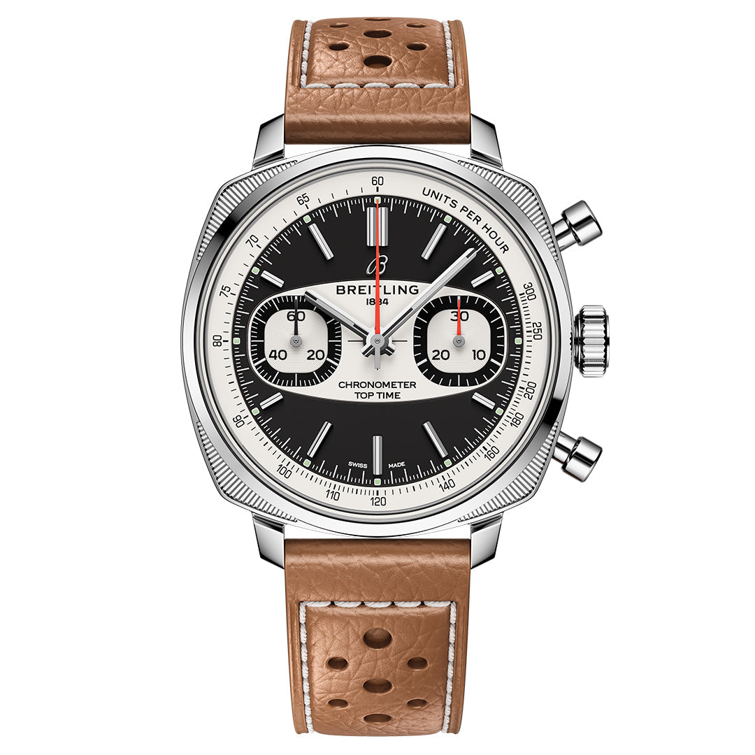 The BREITLING Top Time B01 Racing watch features a modern-retro look with a black and white chronometer dial, two subdials, and a tachymeter scale. It has a brown perforated leather strap, stainless steel case, crown, and two pushers.
