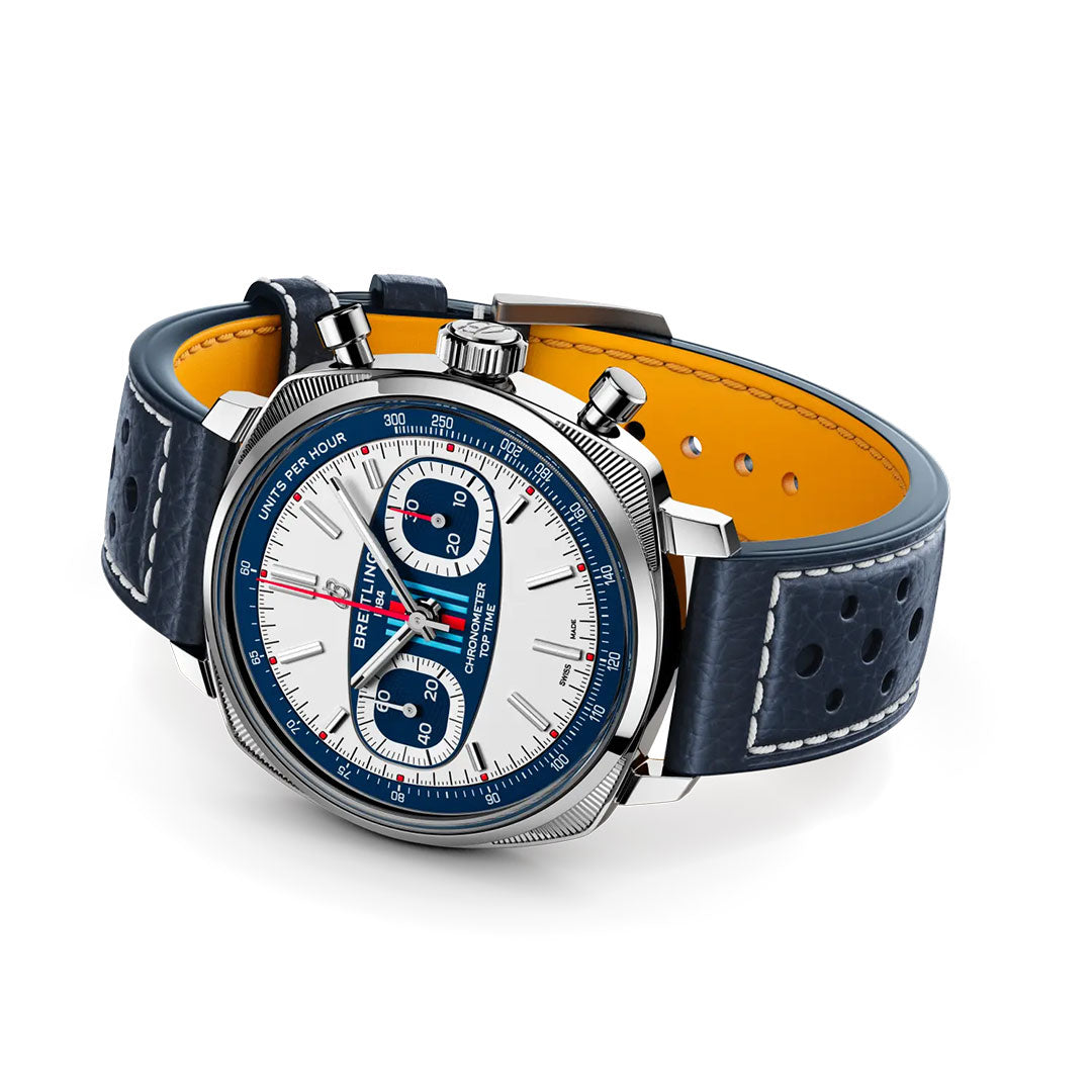 The BREITLING Top Time B01 Racing is a luxury wristwatch with a white dial, blue subdials and bezel, silver accents, blue perforated leather strap with orange lining, and two chronograph buttons—showcasing modern-retro Breitling design.