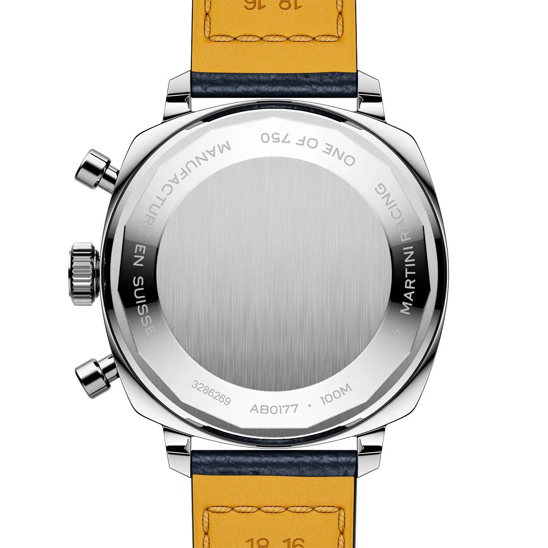 A close-up of the BREITLING Top Time B01 Racing by Breitling shows its stainless steel case back engraved with "MANUFACTURE EN SUISSE," "MARTINI RACING," "ONE OF 750," and "100M," paired with a yellow and blue leather strap.