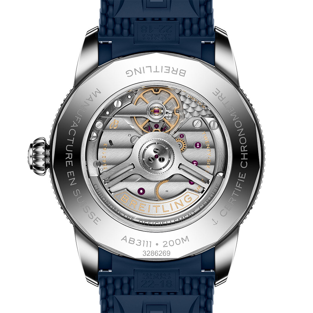 Close-up of the BREITLING Superocean Heritage B31 Automatic 42, highlighting its intricate mechanical movement visible through a transparent caseback, engraved details along the edge, and a blue strap—ideal for fans of classic dive watches.