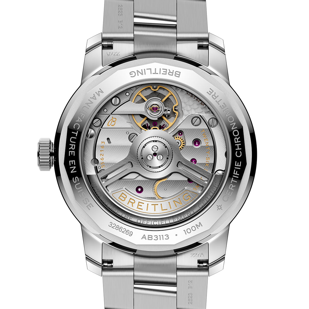 Close-up of a BREITLING Top Time B31 38 watch's back, showcasing the intricate Manufacture B31 automatic movement with visible gears and ruby jewels. The metallic finish shines with engraved "BREITLING," "100M," and model number "AB3113," reflecting vintage proportions.