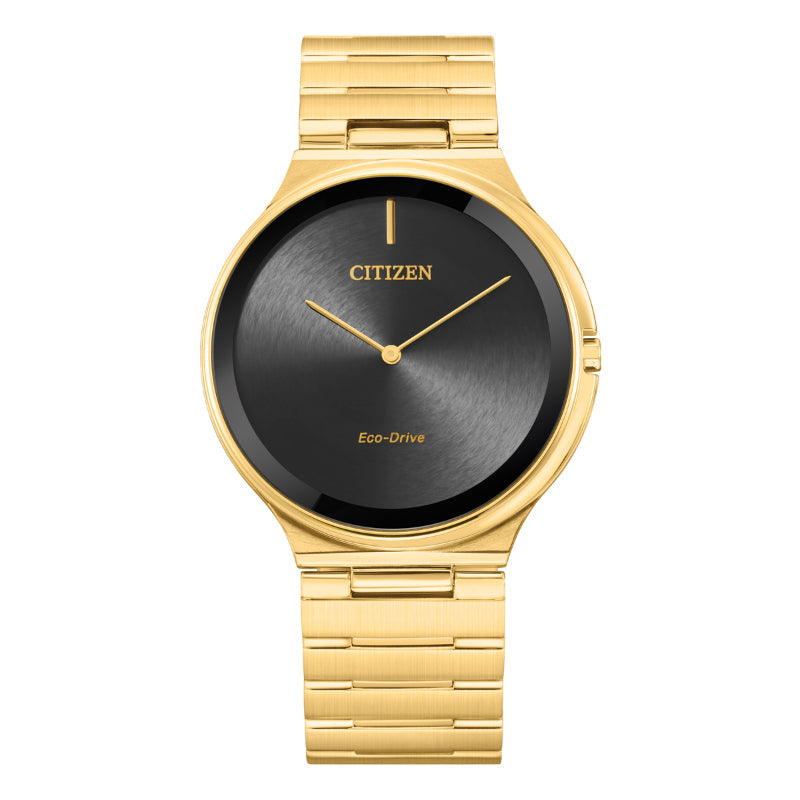 This elegant CITIZEN Stiletto Eco-Drive 39mm Watch features a sophisticated black round face with minimalist gold hour and minute hands, paired with a polished gold metal band.