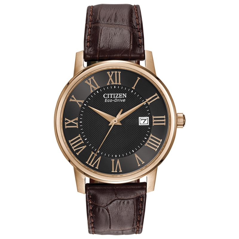 The CITIZEN Corso Eco-Drive 36mm Watch by CITIZEN features a black herringbone dial with rose gold Roman numerals, complemented by a dark brown leather strap. It includes a date display at the 3 o'clock position and is encased in a round rose gold-tone case.