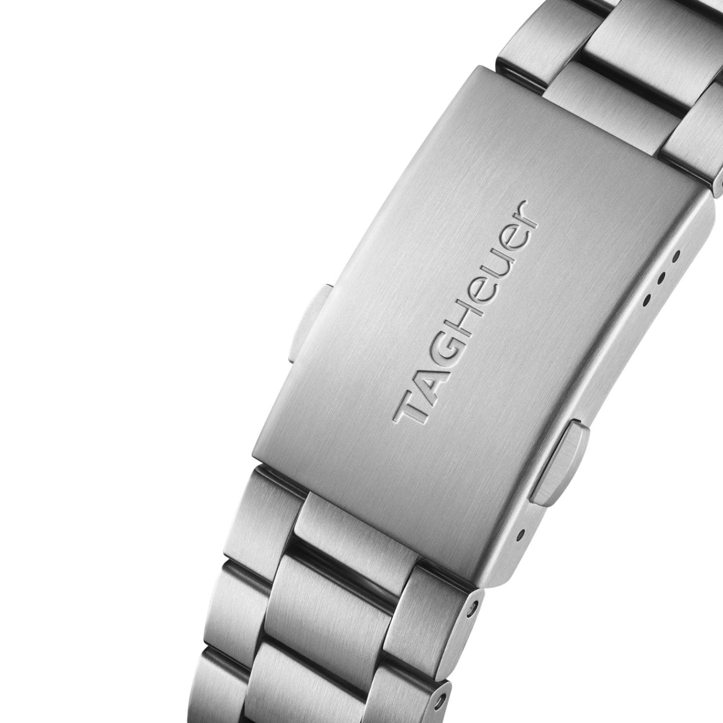Close-up of a silver metal watch clasp engraved with the TAG Heuer logo, attached to a matching brushed metal band. The clasp appears sturdy and well-crafted, reflecting the robust engineering found in motorsport watches like the TAG Heuer Formula 1 Chronograph x Gulf Special Edition Quartz 43mm from TAG Heuer.