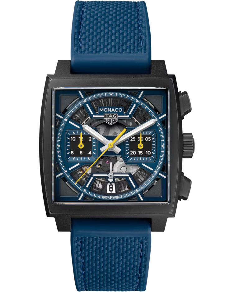 A TAG Heuer Monaco Chronograph Automatic 39mm watch with a square face, featuring a blue strap, a blue and black dial, yellow hands, and two subdials, shown on a plain white background.