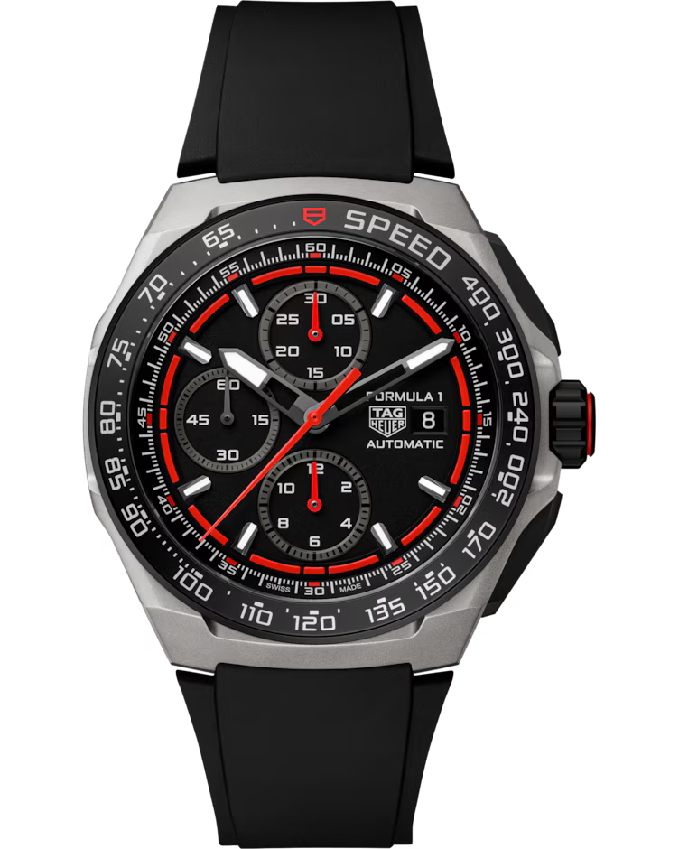 The TAG Heuer Formula 1 Chronograph Automatic 44mm Watch by TAG Heuer features a black dial with three subdials, a date window, red accents, and a black rubber strap. Its bezel is marked “SPEED” and includes a tachymeter scale.