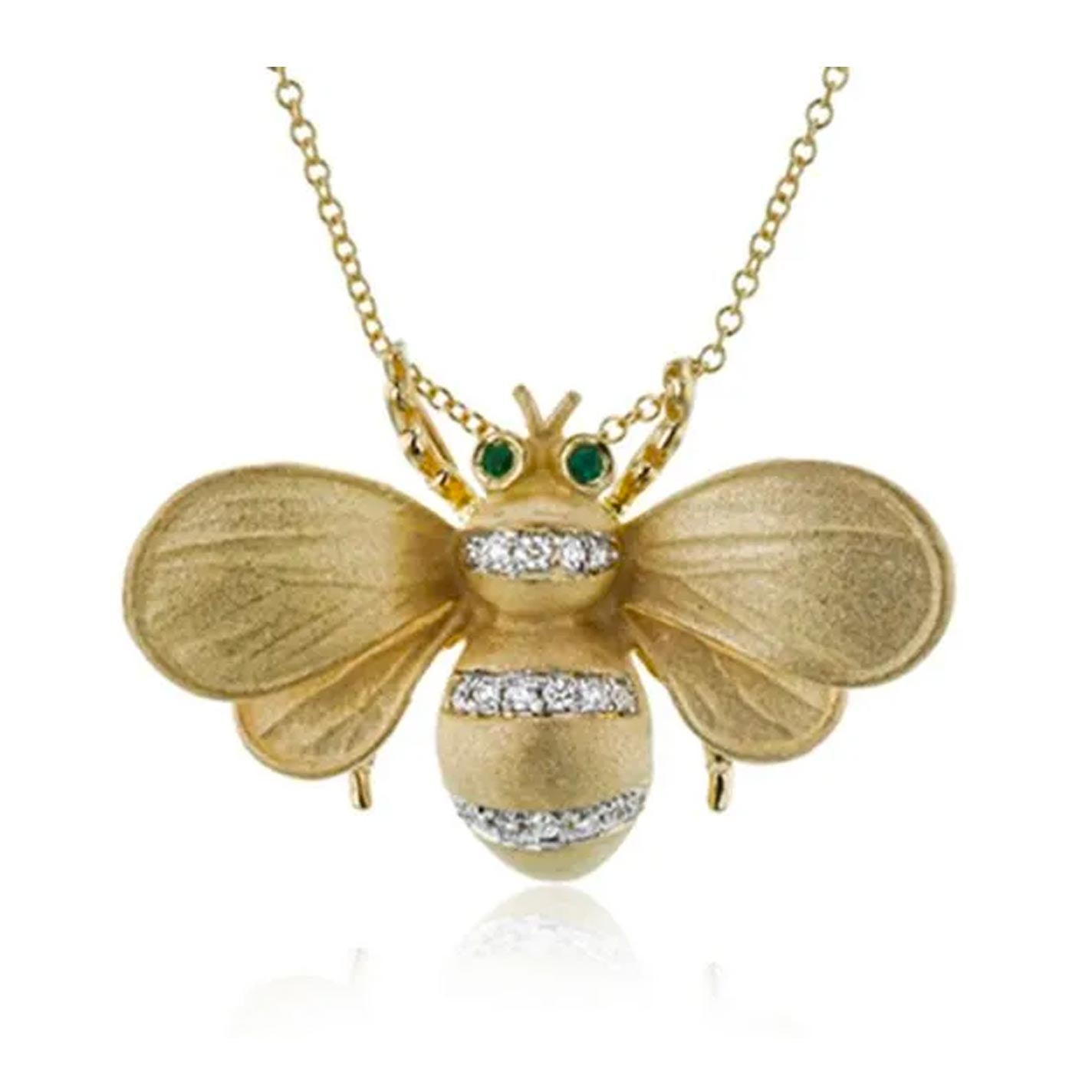The Simon G. Monarch Bee 18K Yellow Gold Diamond Necklace Pendant showcases emerald-colored eyes and dazzling diamond accents on its body, all elegantly hanging from a fine gold chain.