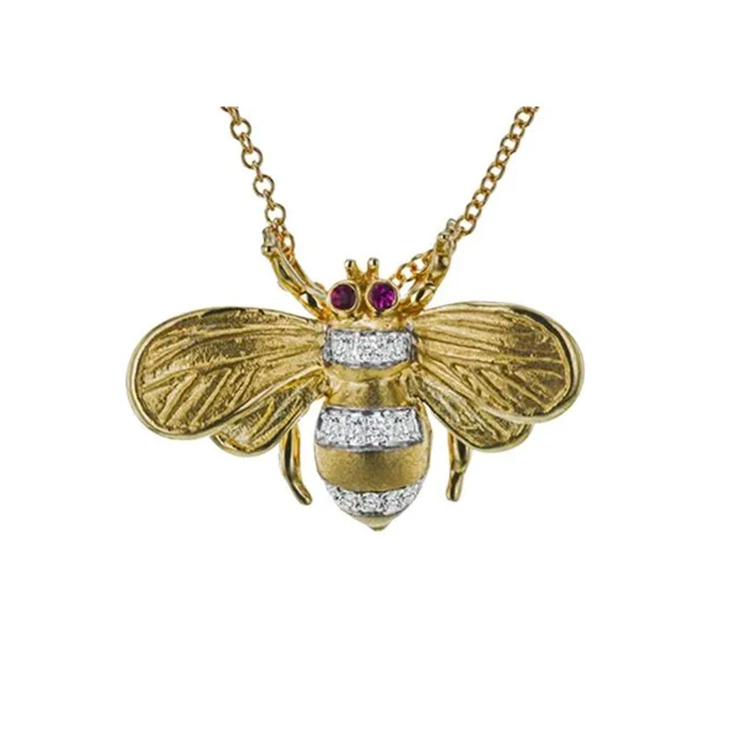 The Simon G. Monarch Bee Necklace Pendant features a beautifully crafted bee design in 18K yellow gold, with intricate wing details and silver stripes. Adorned with red rubies as the eyes and 0.07 ctw diamonds, it hangs gracefully from an elegant chain.