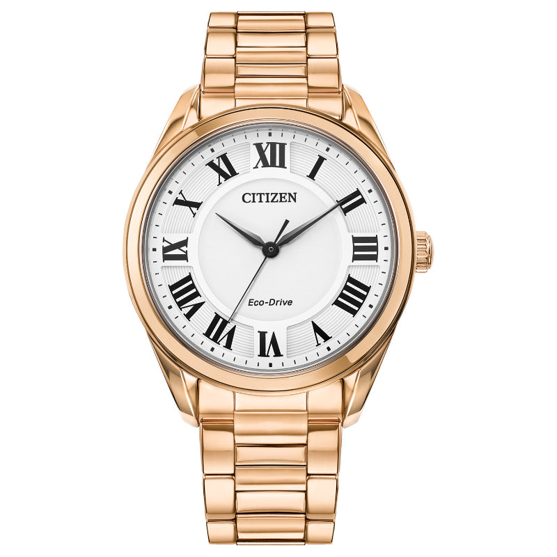 The CITIZEN Fiore Eco-Drive 35mm Watch features a gold-tone case, white dial with black Roman numerals, gold metal link band, and three-hand movement—combining classic elegance and modern eco-friendly technology.