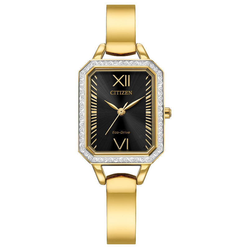 The CITIZEN Silhouette Crystal Eco-Drive 23mm Watch, a stunning ladies' timepiece from CITIZEN, showcases a rectangular black dial with gold Roman numerals at the 12 and 6 positions. The gold case is adorned with small crystals and paired elegantly with a slim gold bracelet band.