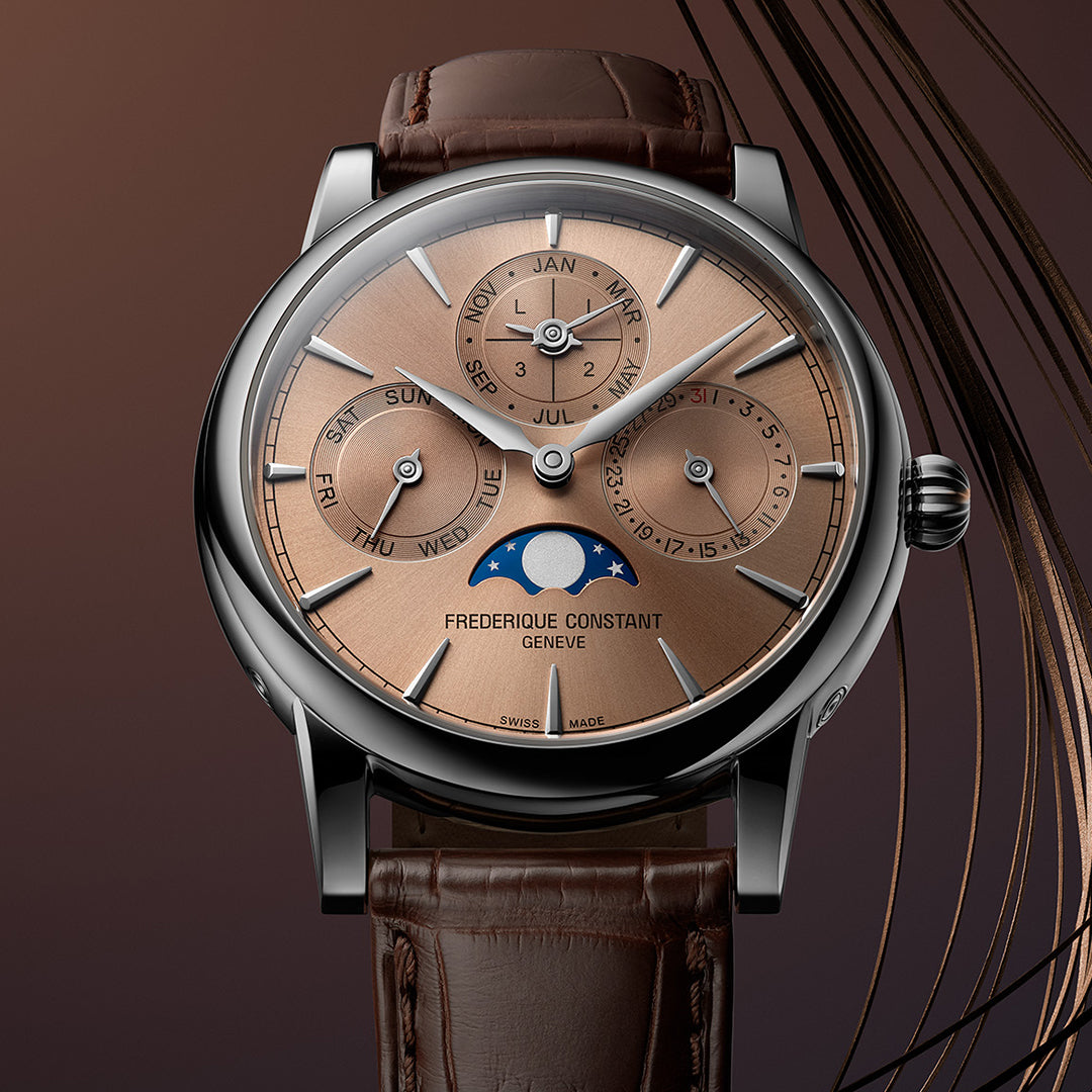 The Frederique Constant Manufacture Classic Perpetual Calendar Automatic 40mm Watch boasts a bronze-toned salmon dial with silver accents and a brown leather strap, highlighting the day, date, month, and moon phase subdial against a rich gradient of brown hues.
