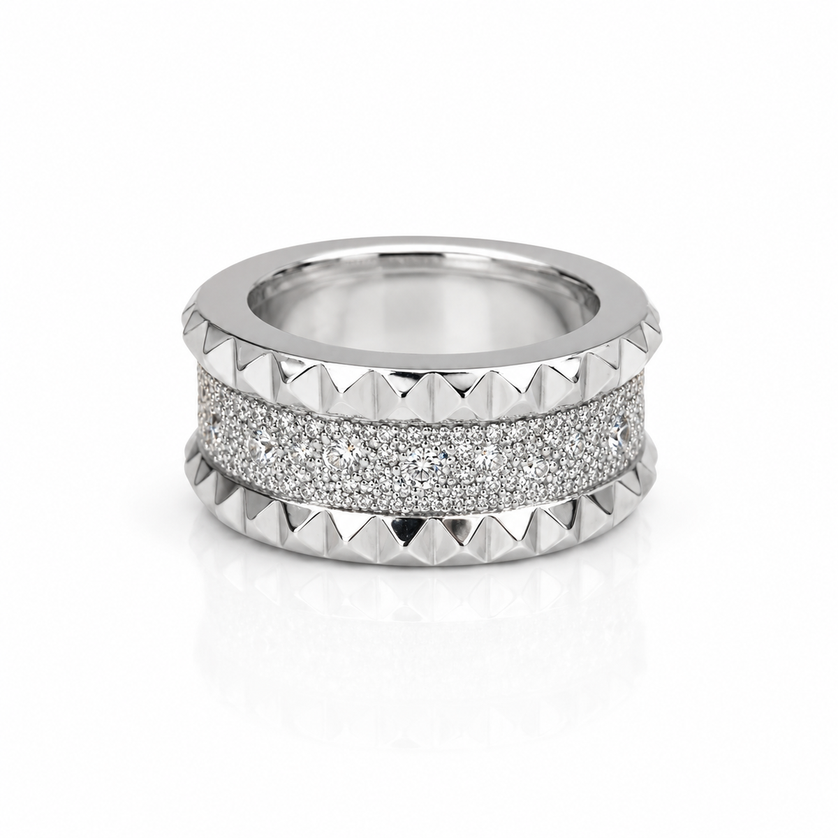 The Roberto Coin Pois Moi Luna 18K White Gold Diamond Ring features a textured band of sparkling diamonds bordered by pyramid-shaped studs, creating a stunning statement piece inspired by Roberto Coin’s signature style.