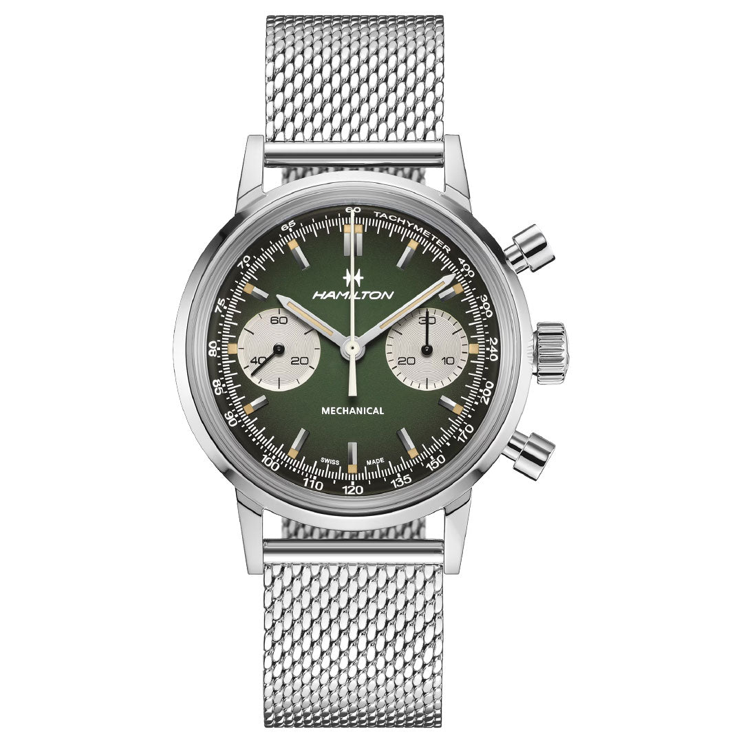 The Hamilton American Classic Intra-Matic Mechanical Chronograph H 40mm Watch features a silver case, green dial with two subdials, mesh stainless steel strap, vintage racing inspiration, three side buttons, and bold white hour markers.