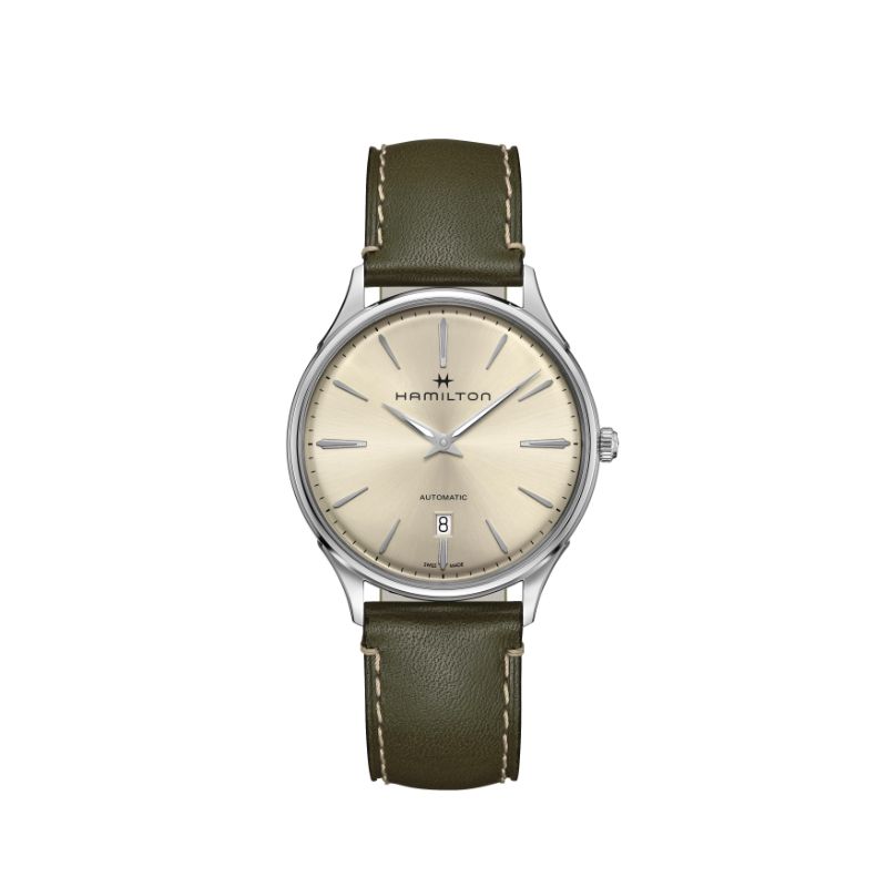 The Hamilton Watch Jazzmaster Thinline Auto 40mm Watch showcases an elegant design with a beige dial and date display. It features a silver case paired with an olive green leather strap for a sophisticated look. The timepiece is completed with silver-toned hour markers and hands, enhancing its refined aesthetic.