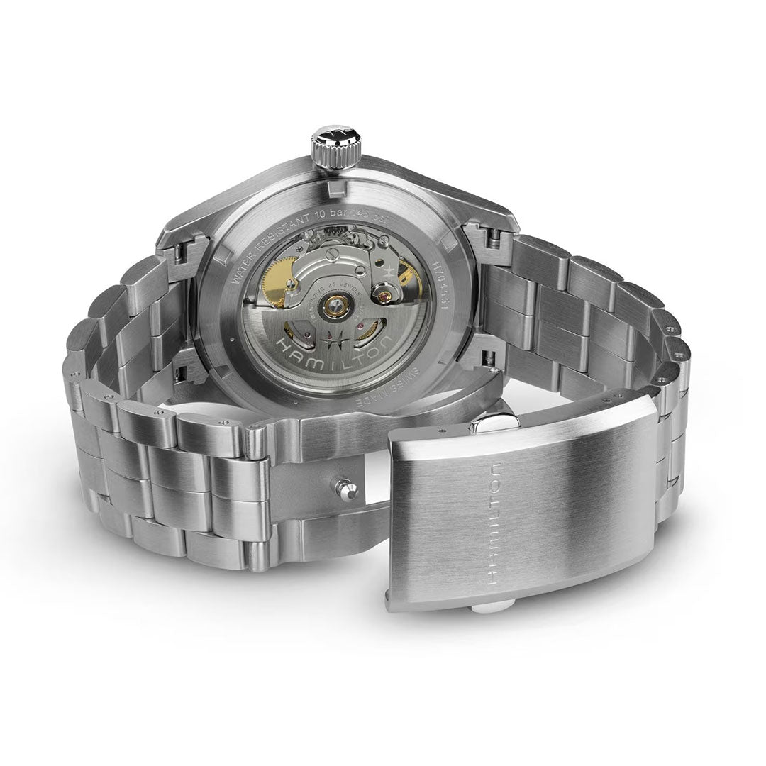 The Hamilton Khaki Field Auto 38mm Watch by Hamilton Watch features an open bracelet, exhibition case back displaying the H-10 automatic caliber, and a clasp engraved with the brand’s logo, reflecting its military heritage design.