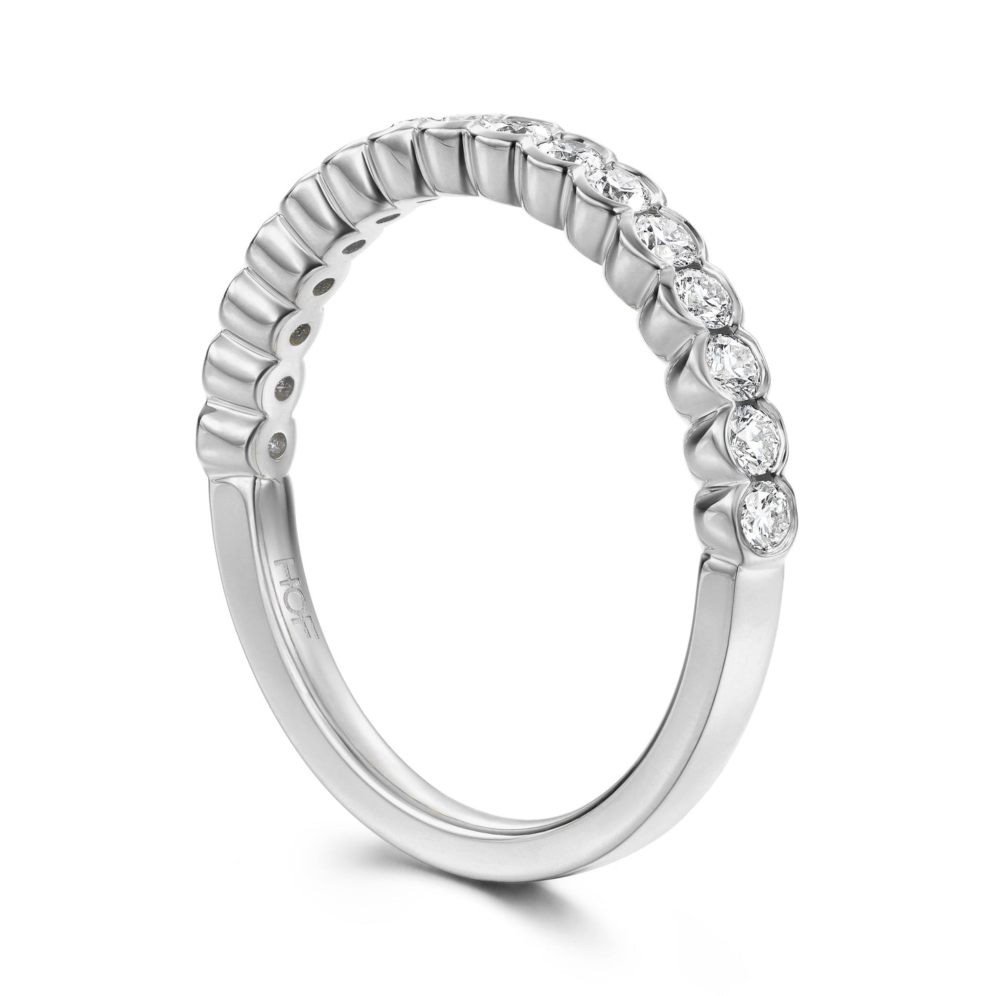 Introducing the Hearts On Fire Isabelle 18K White Gold Bezel Round Brilliant Diamond Anniversary Ring, a silver wedding band adorned with a row of small, sparkling round diamonds along the top half. Crafted from 18 karat white gold, this smooth and shiny ring beautifully exhibits an elegant arrangement of gemstones.