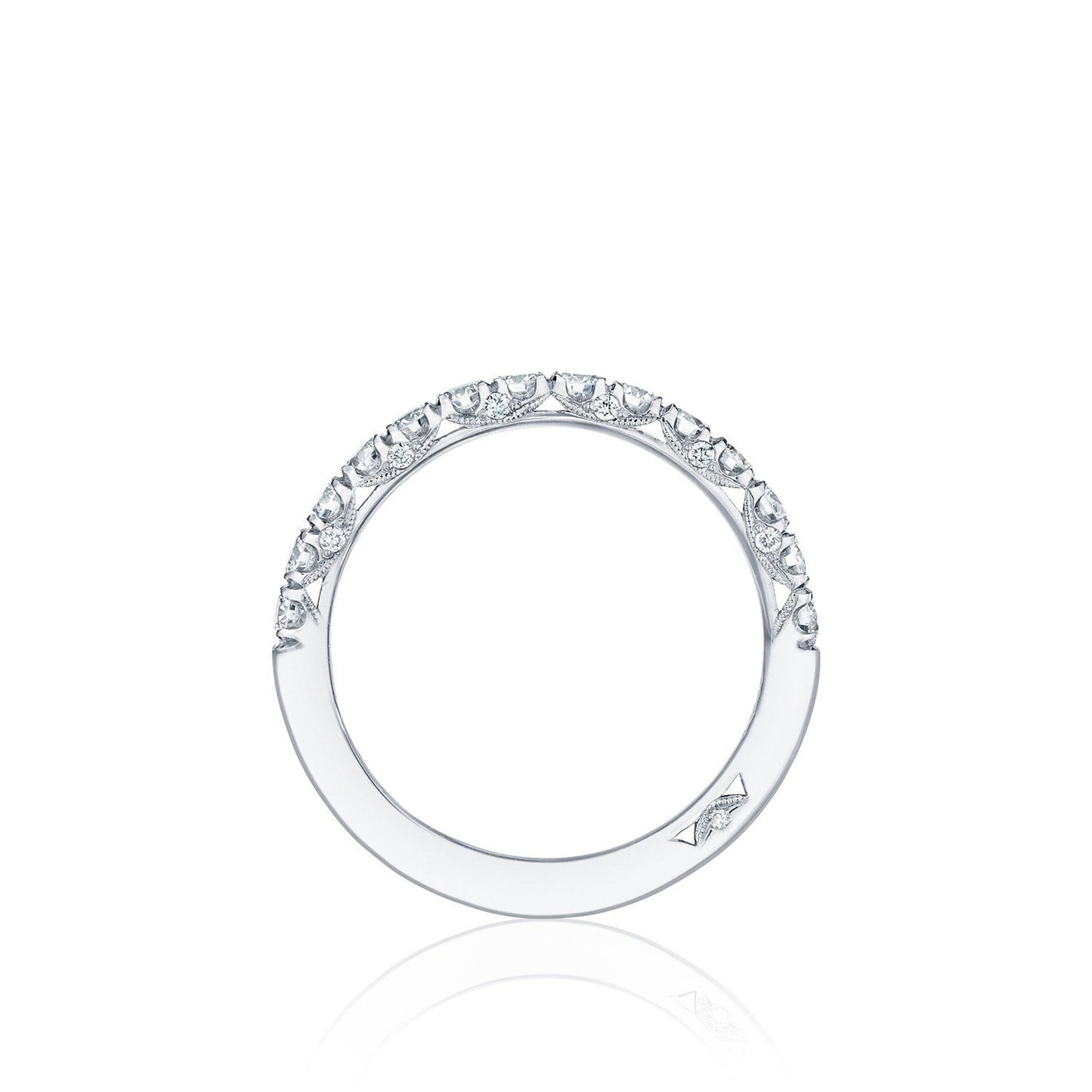The Tacori Petite Crescent Platinum Round Brilliant Diamond Anniversary Ring features a minimalist and elegant design with small diamonds adorning half of the band, set against a plain white background.