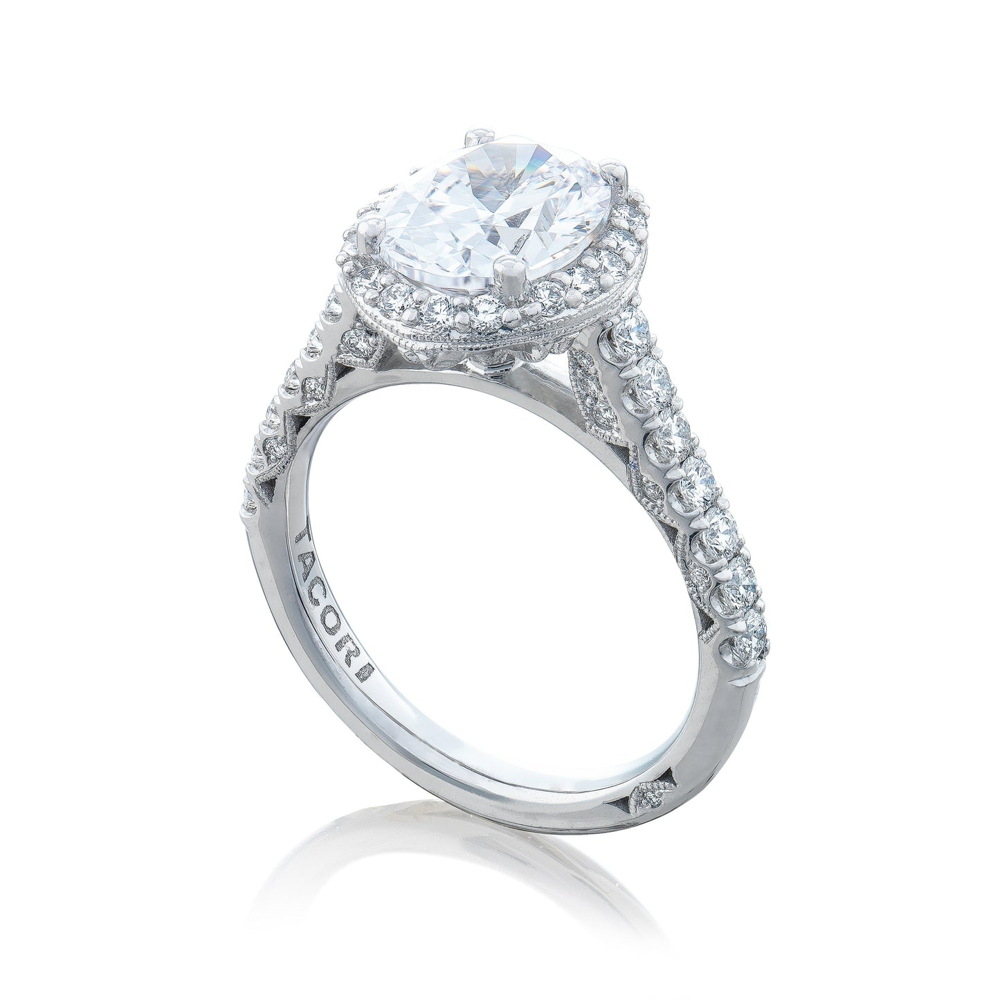 A sophisticated Tacori Petite Crescent engagement ring, crafted by the esteemed brand Tacori, highlighting a grand oval center stone encircled by a halo of smaller diamonds. The band showcases the Petite Crescent design and features intricate detailing with additional diamonds.
