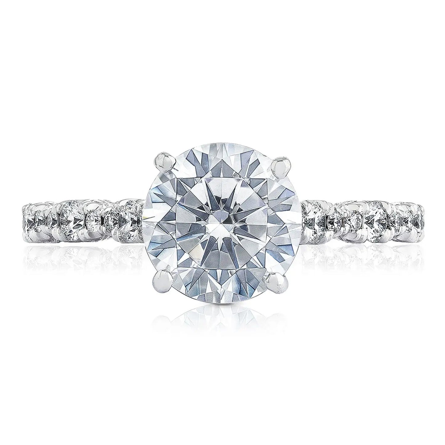 This exquisite Tacori Petite Crescent RoyalT Marquise Shape Design Detail Round Brilliant Diamond Anniversary Ring, crafted by TACORI gemologists, boasts a striking round diamond at its center, surrounded by smaller diamonds elegantly placed along the band. Set against a white background, it highlights the brilliance and intricate craftsmanship of the design.