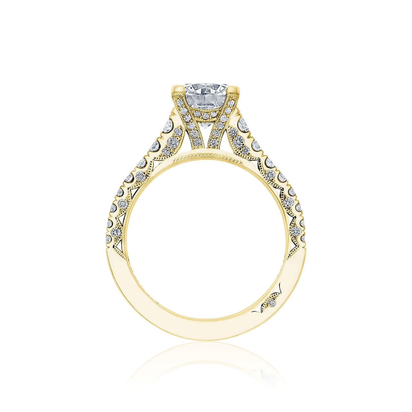 A detailed side view of the Tacori Petite Crescent 18K Yellow Gold Round Brilliant Solitaire Semi Mount Engagement Ring reveals its ornate design, showcasing a large round diamond. The band features intricate filigree patterns adorned with smaller diamonds, presenting an elegant and luxurious appearance.