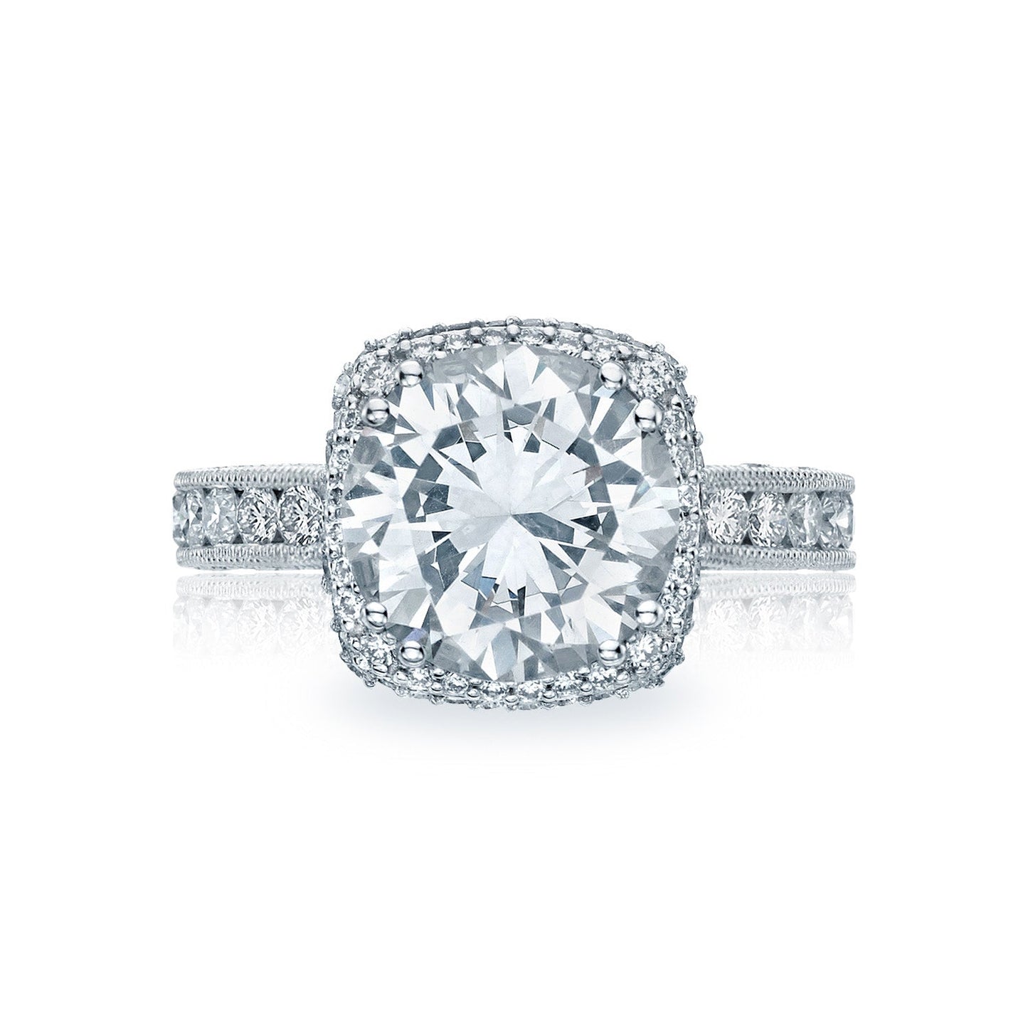 The Tacori Classic Crescent RoyalT Platinum Round Brilliant Semi Mount with Diamond Band and Halo Engagement Ring showcases a large round diamond at its center, surrounded by a halo of smaller diamonds. The platinum band sparkles with its adornment of tiny diamonds, offering an elegant and dazzling appearance.