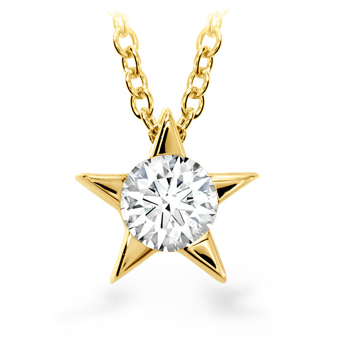 A timeless beauty, the Hearts On Fire Illa Star Necklace from the renowned brand Hearts on Fire showcases an 18 Karat Yellow Gold Pendant with a star-shaped design. It features round diamonds that sparkle brilliantly at its center, elegantly suspended on a gold chain against a pristine white background.