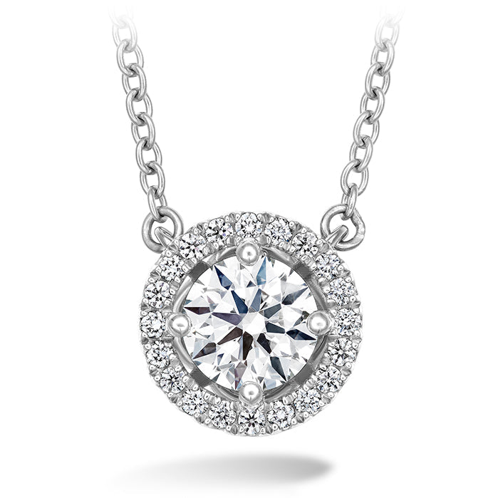 The Hearts On Fire Joy Necklace by Hearts on Fire is a white gold piece featuring a classic chain design with a joy pendant. It showcases a central round diamond surrounded by smaller diamonds, creating a stunning focal point.