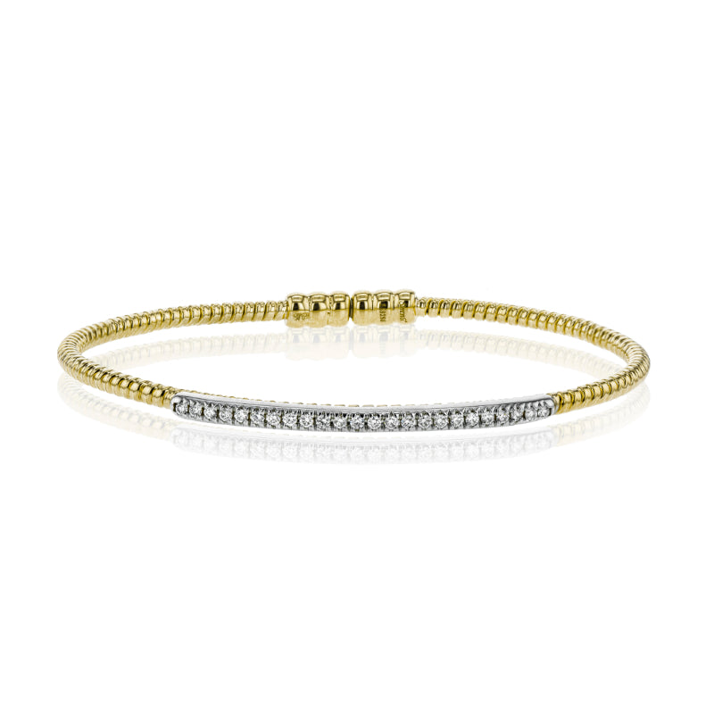 The Simon G. 18K Yellow Gold Diamond Bangle by Simon G showcases a thin band embellished with a row of dazzling white diamonds arranged in a straight line across the front. This bracelet has a reflective surface, producing a mirror-like effect against a white background.