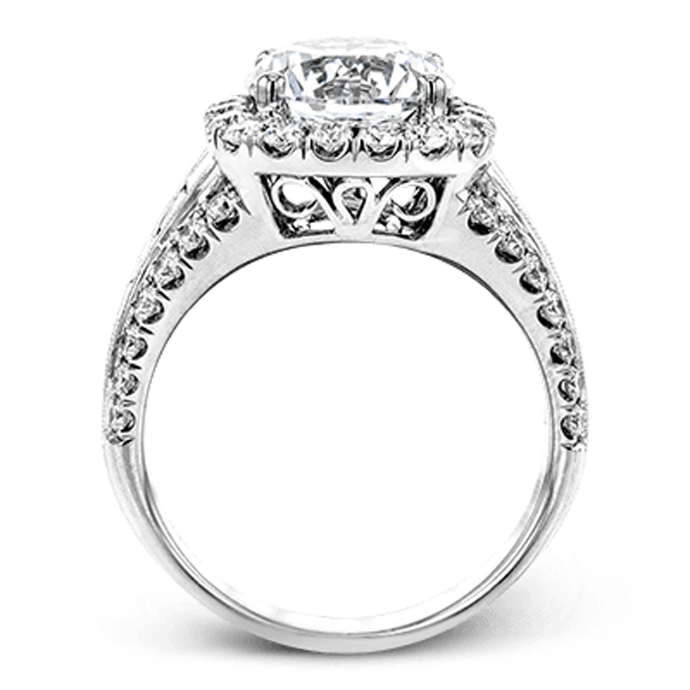 Introducing the Simon G 18K White Gold Baguette Halo Diamond Ring, a stunning engagement ring that features a captivating halo design. It showcases a prominent central round diamond encircled by smaller diamonds along the band, with exquisite detailing beneath the center stone, all crafted by the renowned brand Simon G.