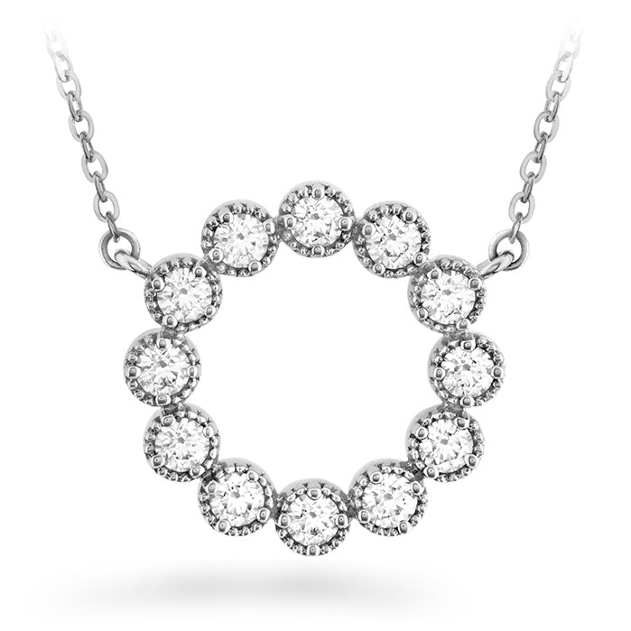 The Hearts On Fire Liliana Milgrain Necklace by Hearts on Fire features a milgrain circle pendant adorned with ten dazzling round diamonds, each set in a beaded setting. The elegant chain beautifully complements this stunning piece against the plain white background.