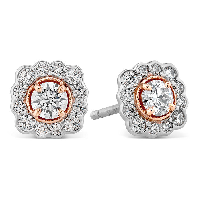 A close-up of the Hearts On Fire Liliana Flower Stud Earrings reveals an elegant design, showcasing a central round diamond encircled by smaller diamonds in a scalloped floral pattern. The rose gold accents enhance the sparkle of the piece, exemplifying the craftsmanship of Hearts on Fire.