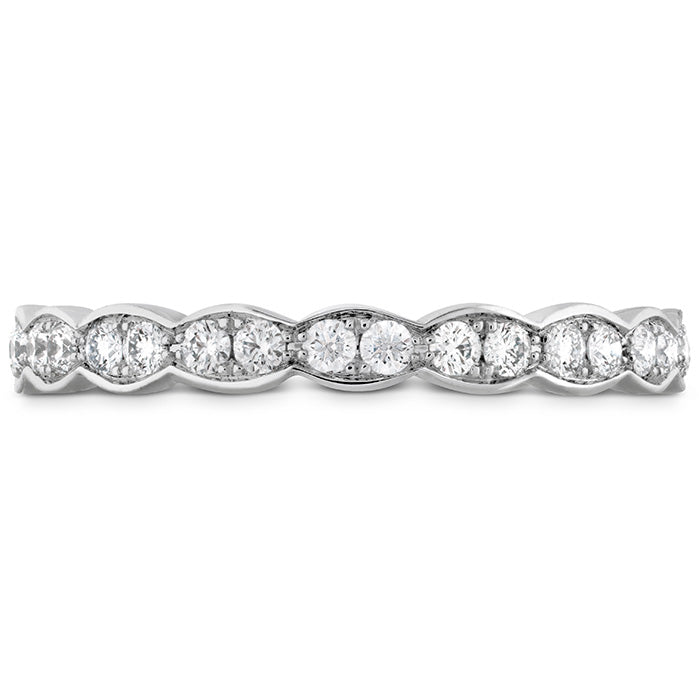 A detailed view of the Hearts On Fire Lorelei Floral 18K White Gold Round Brilliant Diamond Eternity Ring reveals a series of round and marquise-shaped diamonds arranged in an elegant, alternating pattern. The simple white background accentuates the radiance and intricate design of this exquisite wedding band by Hearts on Fire.