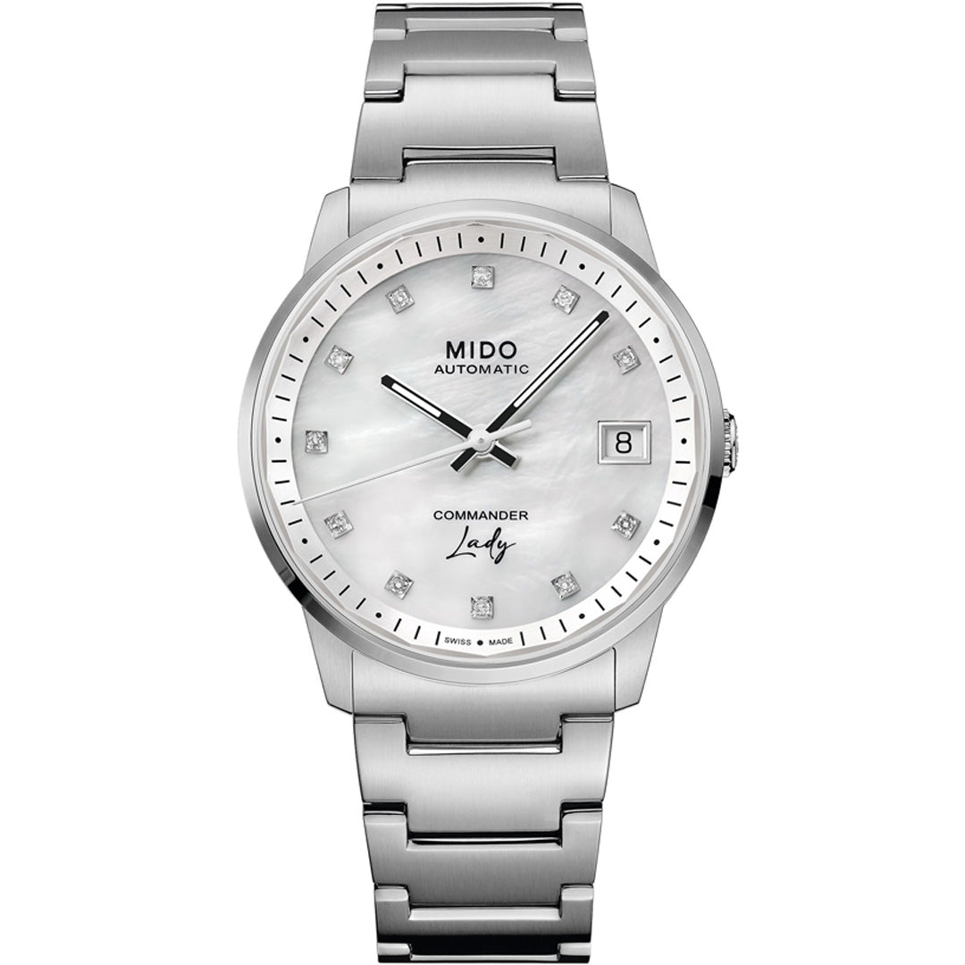 The MIDO Commander Lady Automatic 35mm Watch for women features a silver metal bracelet, white mother-of-pearl dial with diamond hour markers, date window at 3 o’clock, and displays "MIDO AUTOMATIC" & "COMMANDER Lady" on the face.