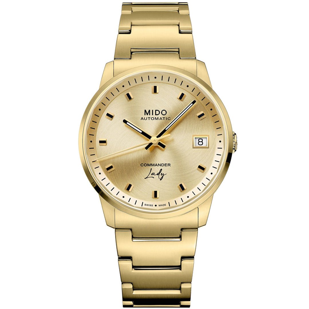 The MIDO Commander Lady Automatic 35mm Watch features a gold dial, gold hour markers, date window at 3 o’clock, and a gold metal bracelet. "MIDO AUTOMATIC" and "COMMANDER Lady" are displayed on the elegant Swiss-made dial.