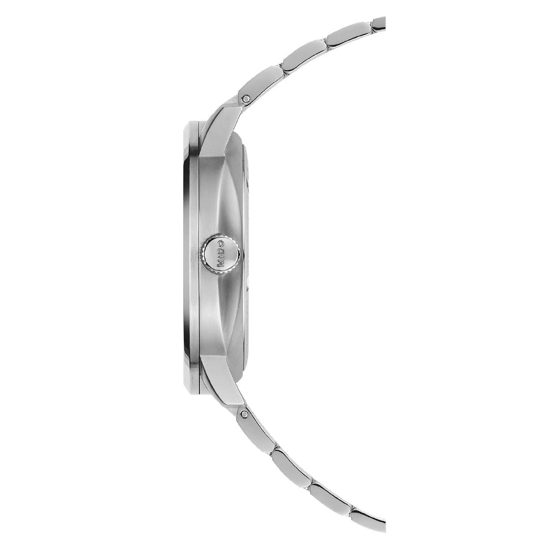 Side view of the MIDO Commander Gradient Automatic 40mm Watch, a slim, silver wristwatch with metal band and round crown, transparent case back, from MIDO, shown against a white background.