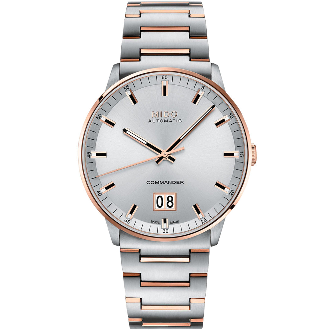 The MIDO Commander Big Date Automatic 42mm Watch features a silver dial, rose gold accents, a stainless steel bracelet, minimalist hour markers, Caliber 80 automatic movement, and a date window at 6 o’clock.