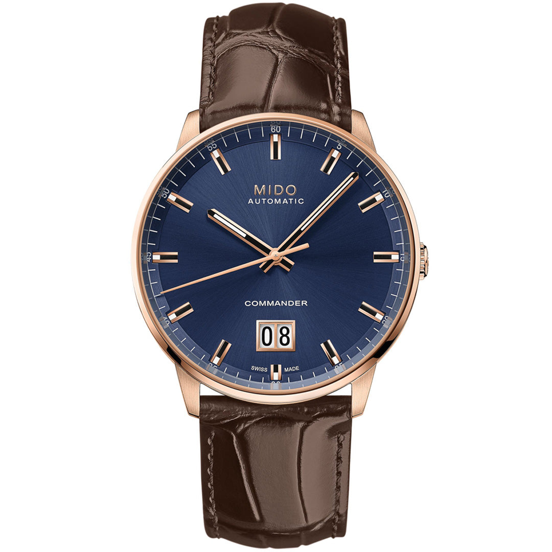 The MIDO Commander Big Date Automatic 42mm Watch features a blue dial, gold-tone case, gold hour markers and hands, brown leather strap, and date display at 6 o'clock with "MIDO AUTOMATIC" below 12 o'clock.