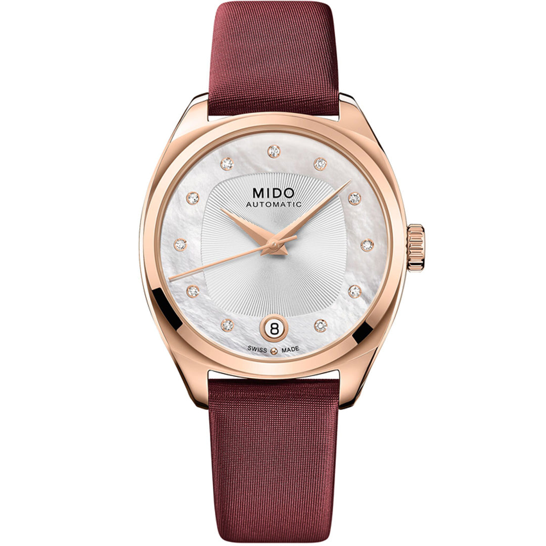 The MIDO Belluna Royal Lady Special Edition Automatic 33.4mm Watch features a rose gold case, white textured dial with diamond markers, 80-hour power reserve, date at 6 o’clock, and a maroon leather strap.